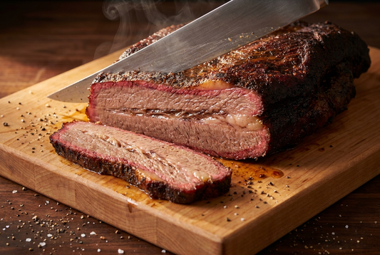 Sliced brisket with smoke ring on a maple cutting board